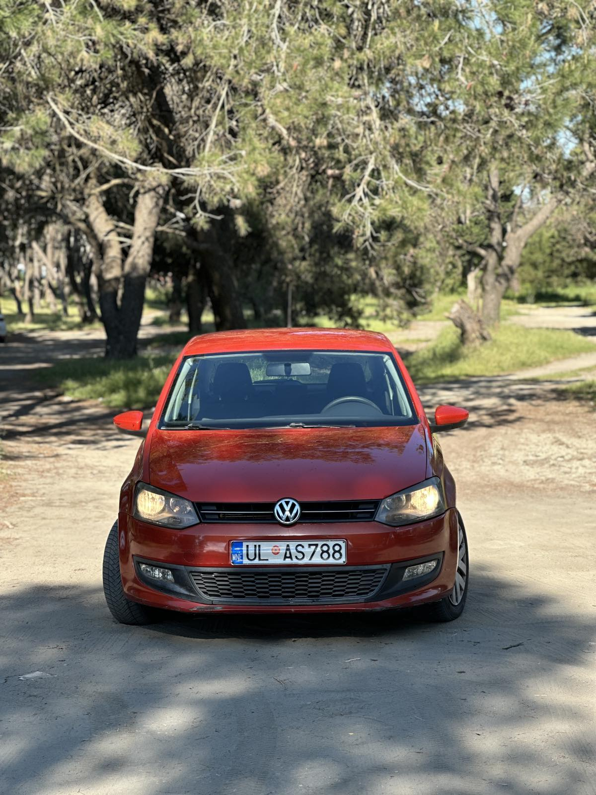 Car parked in front of a modern building during a sunny day in Ulcinj