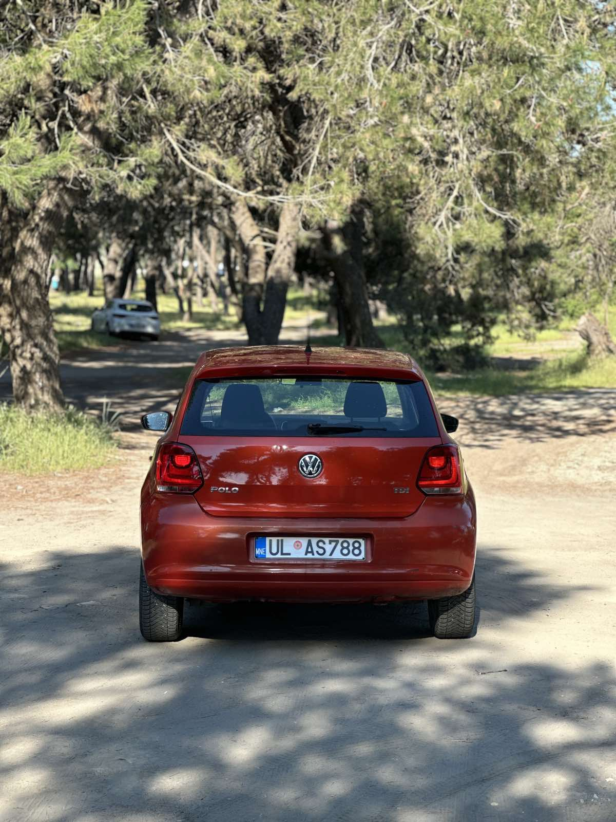 Car parked in front of a modern building during a sunny day in Ulcinj