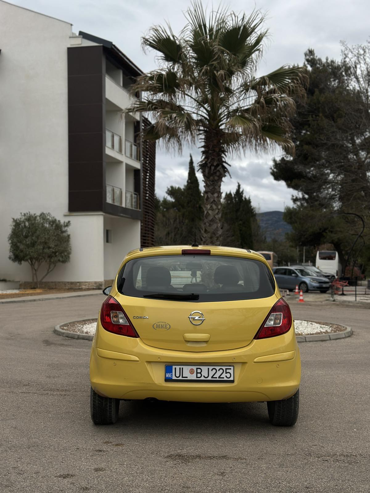 Car parked in front of a modern building during a sunny day in Ulcinj