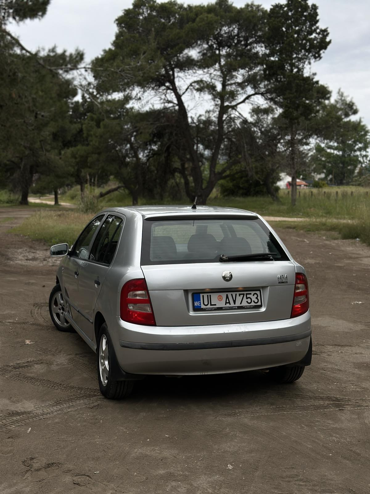 Car parked in front of a modern building during a sunny day in Ulcinj